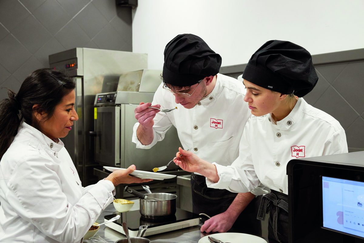 Students cooking in the kitchen of Joviat's restaurant