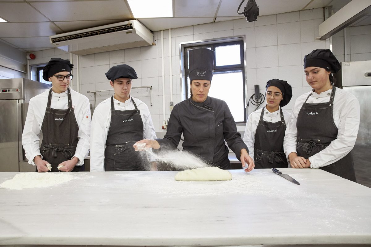 Teacher and students preparing bread dough